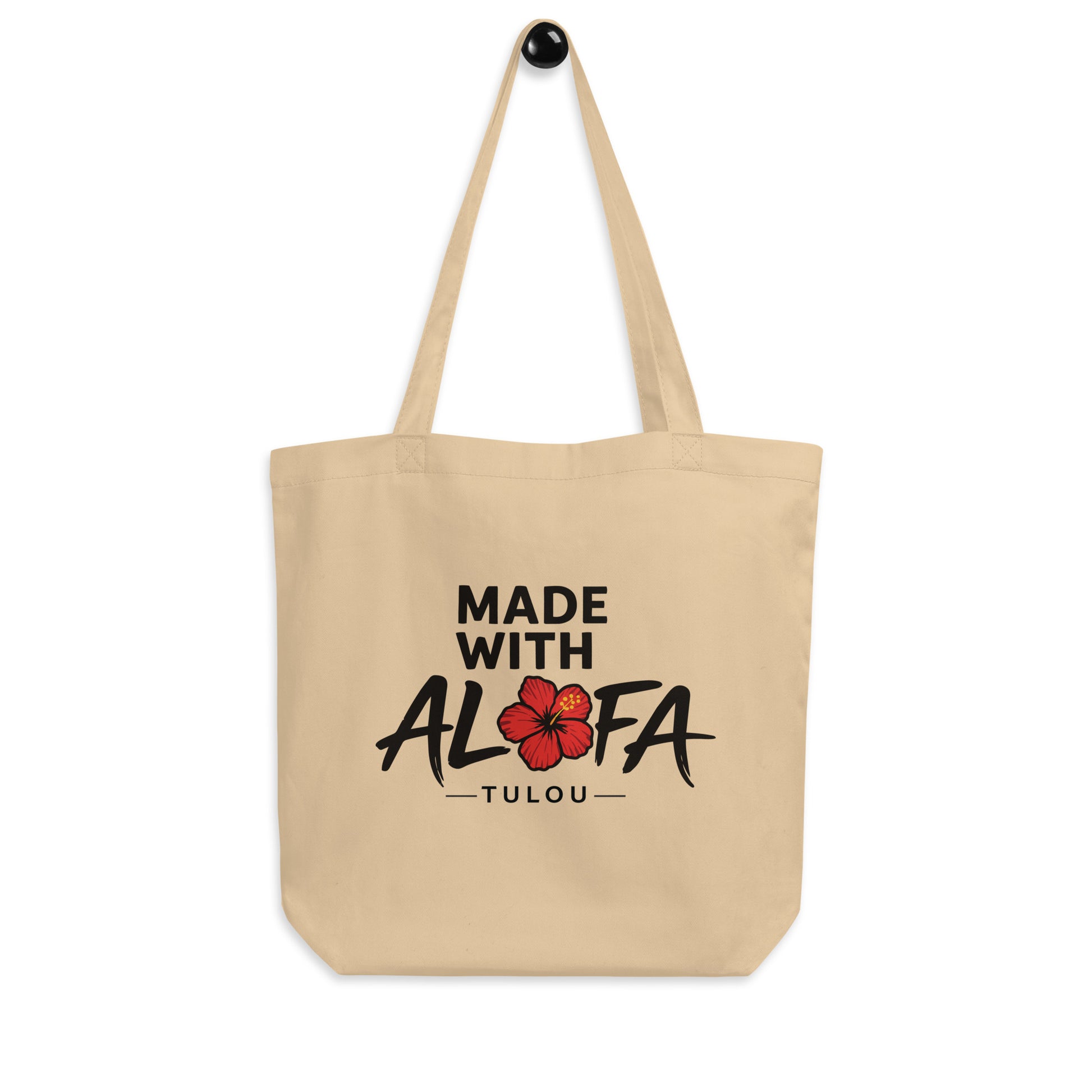 Beige tote bag with 'Made with Alofa Tulou' text and a red flower design on a white background
