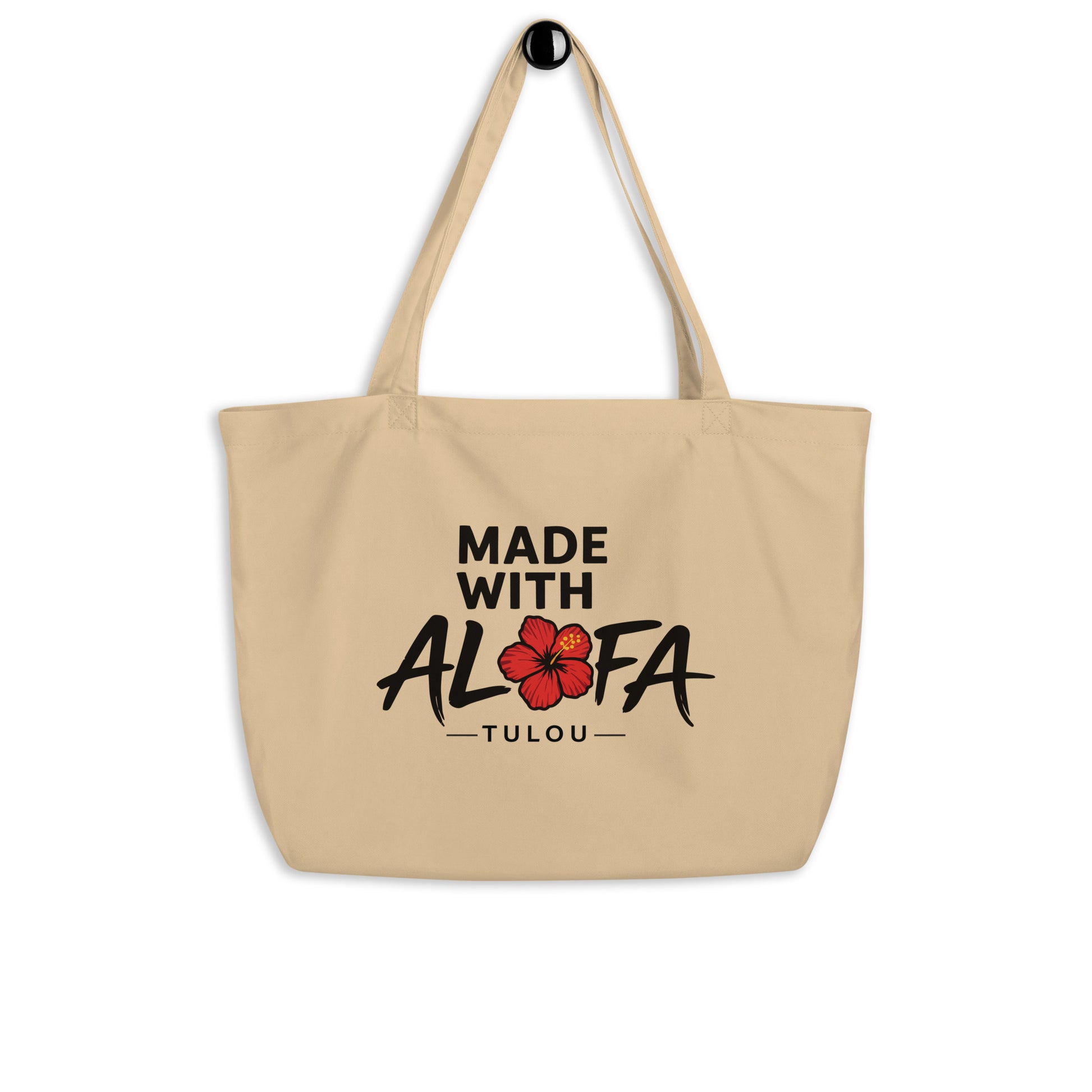 Beige tote bag with 'Made with Alofa Tulou' text and floral design on a white background
