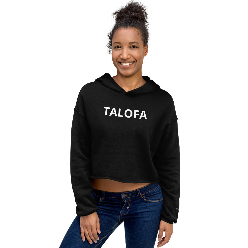 Woman wearing a black hoodie with a Talofa text design on a white background